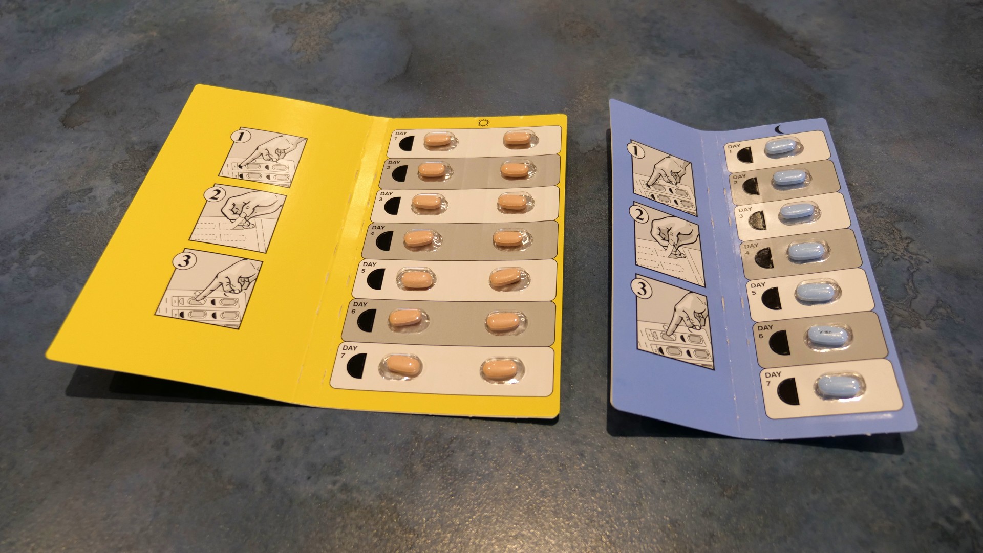 A yellow and blue packet of small tablets on a kitchen bench.