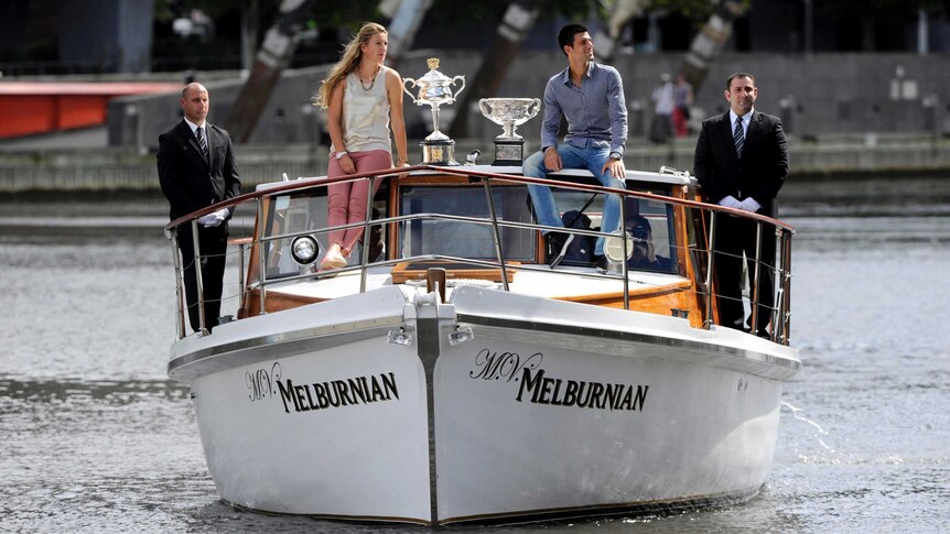 Victoria Azarenka and Novak Djokovic arrive with the Australian Open trophies.