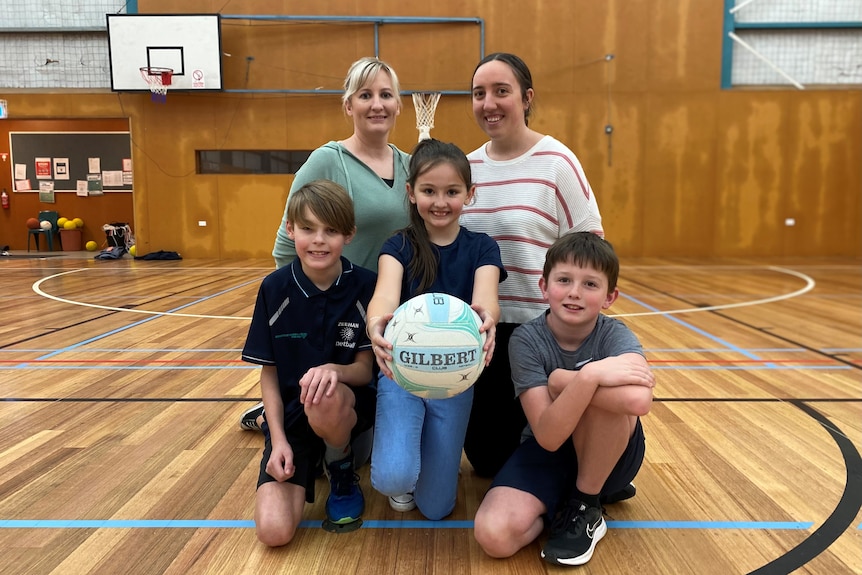 Netball coach Aleisha Maskell and Jessica Bonner with young players.