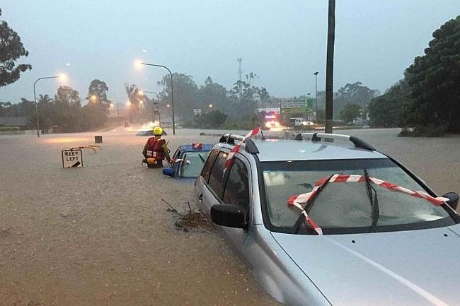 Two cars with floodwaters up to the door handles.