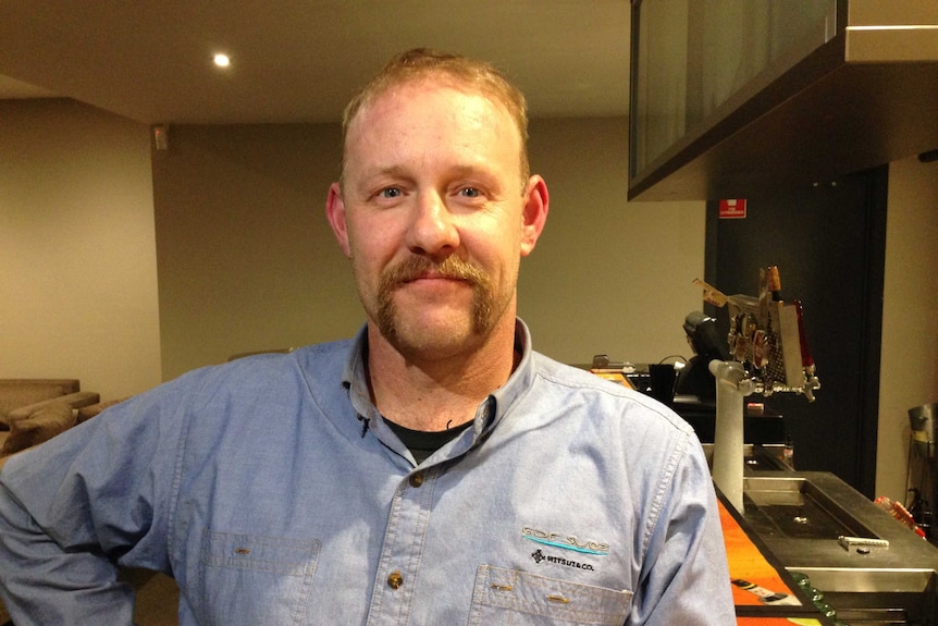 Gary Sevenson standing in front of the bar at the Churchill Hotel