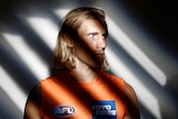 A portrait of a footballer with shadows across his face