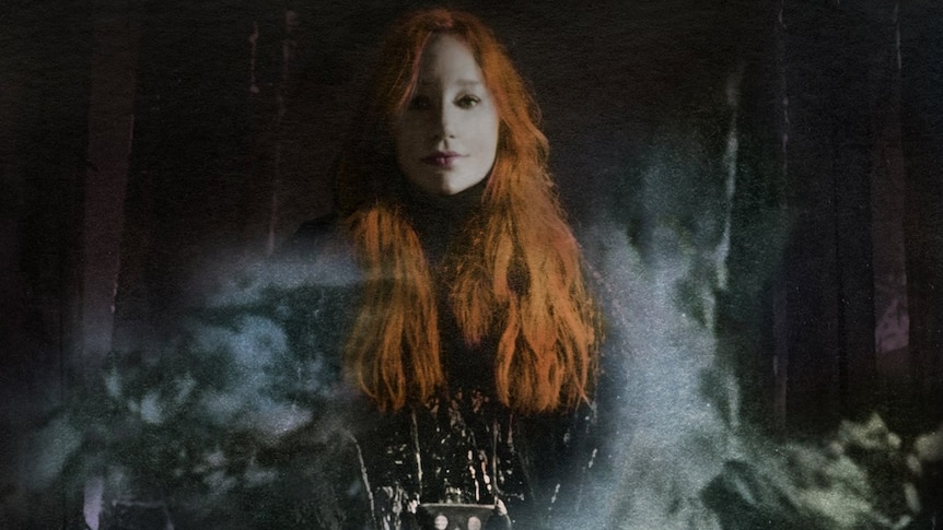 A deliberately dark and faded photo of Tori Amos