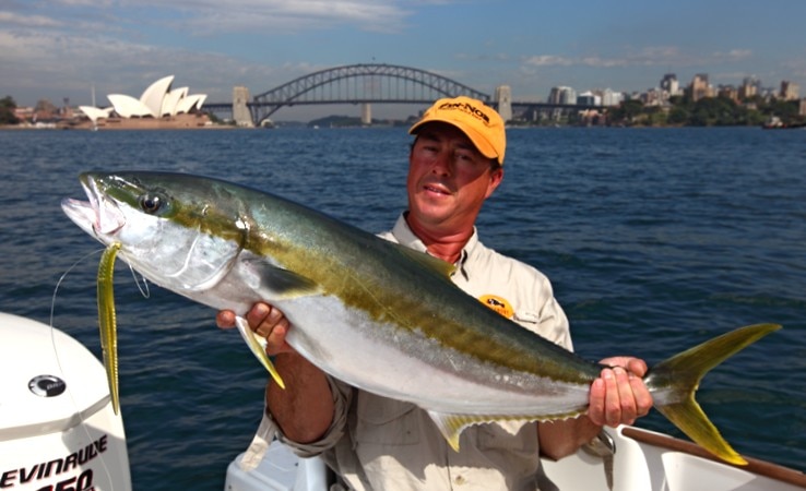 Man holding a fish on a boat
