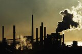 Great silhouetted pic of industrial chimmneys pouring out smoke.