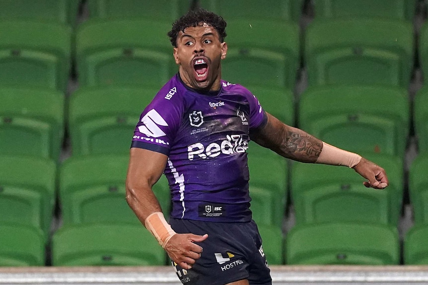 Josh Addo-Carr of the Melbourne Storm screams with his arms akimbo after scoring a try.