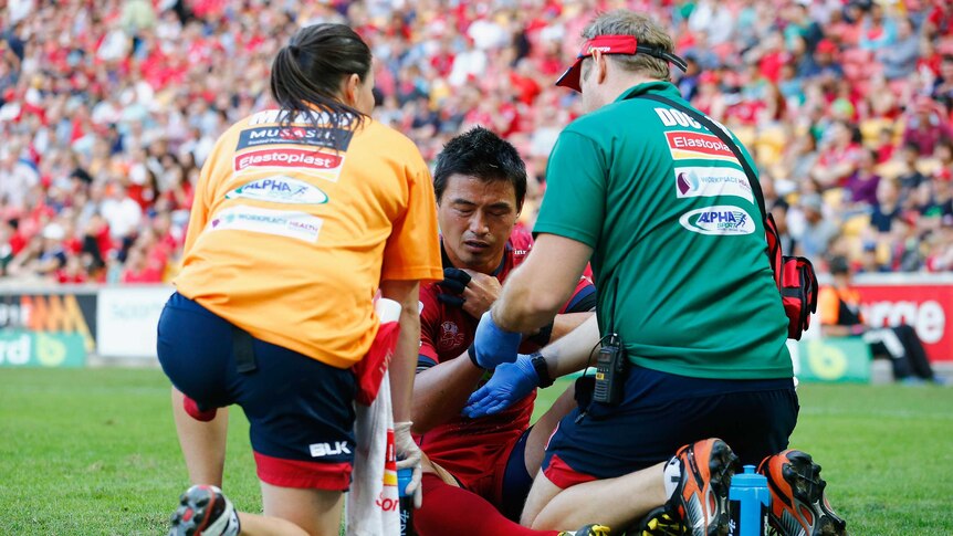 Ayumu Goromaru of the Reds is treated for an injury during the Super Rugby game against Sunwolves.