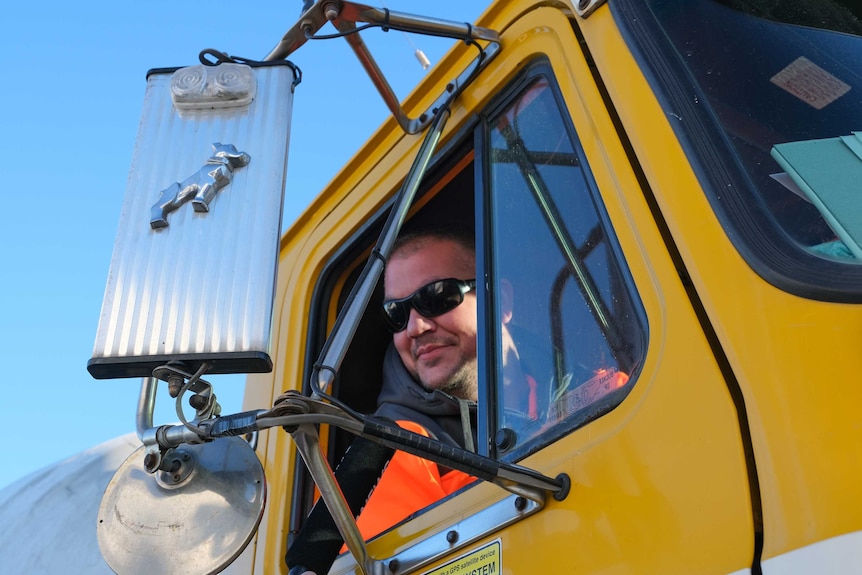 Truck driver Chicco Boustani leaning out of window.