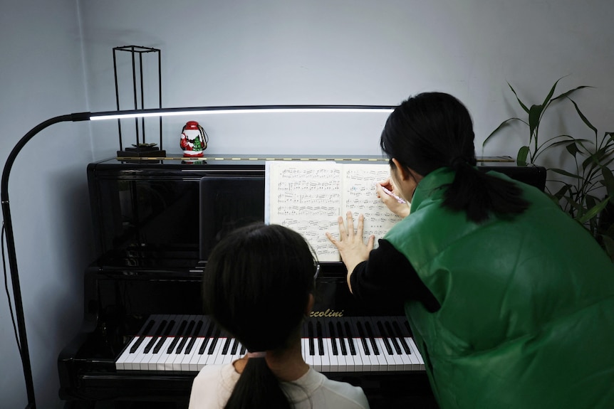 A piano teacher gives lessons in Beijing.