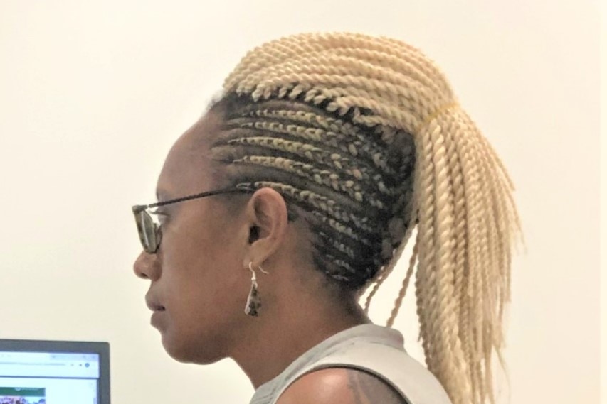 Side profile of Dodi's long braids.