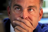 A trader looks at the screens at the NYSE