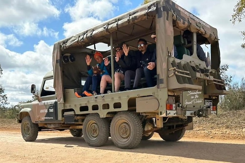 A group of tourists sit inside a 6x6 Land Rover while on a tour in the Blue mountains.