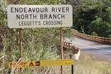 Leggett's Crossing sign and bridge across Endeavour River in far north Queensland.