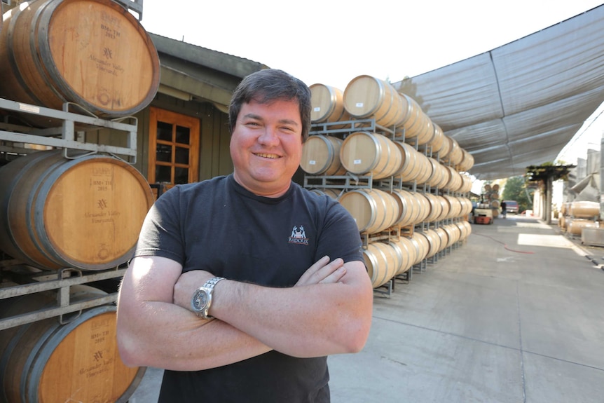 Dozens of wine barrels are stacked up on top of one another, at Harry Wetzel's vineyard.