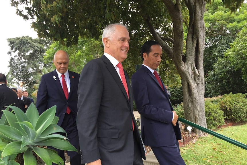 Australian Prime Minister Malcolm Turnbull and Indonesian President Joko Wikodo walk together in Australia on February 26, 2017.