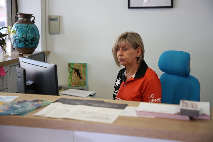 Jo Hersey, a Katherine politician, is sitting at a desk in her constituency.