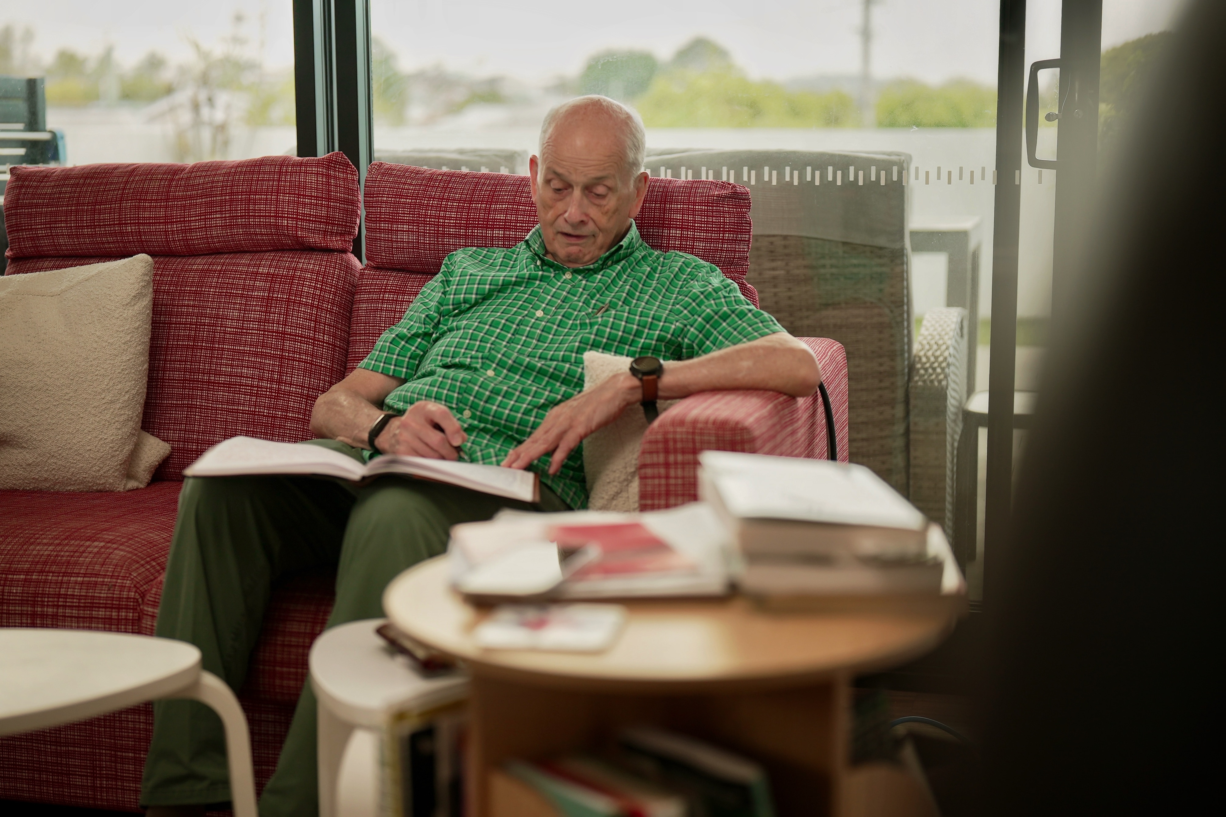 a man in a green shirt on a couch