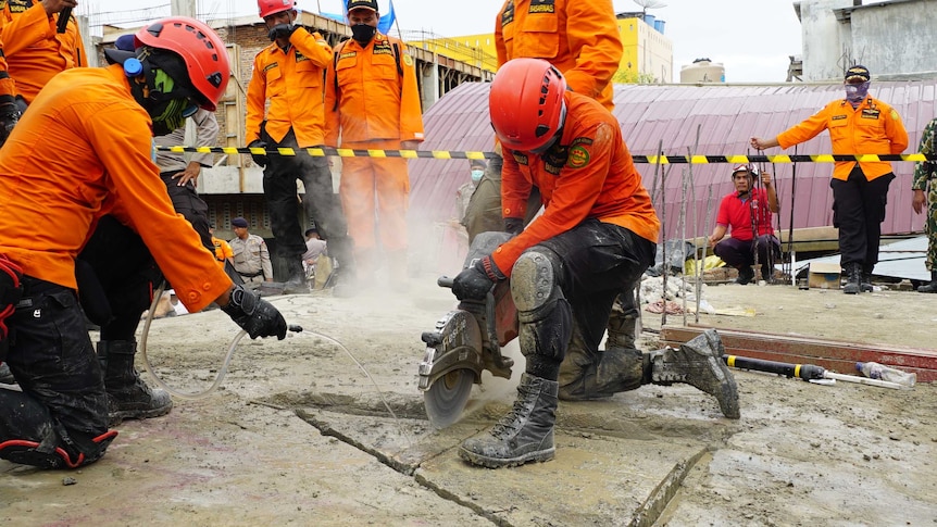 Rescue crews drill into the ground as they look for survivors of the Indonesia earthquake.