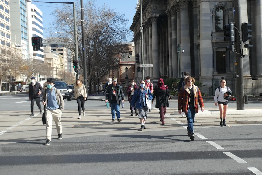 Pedestrians crossing King William Street in Adelaide's CBD after a lockdown.