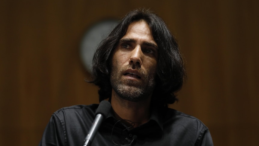 Behrouz Boochani speaks at an event inside Parliament House