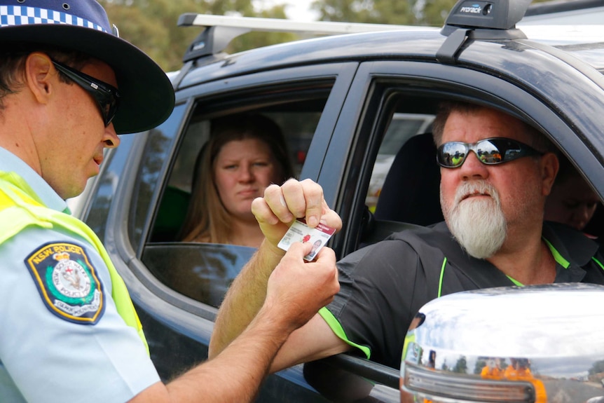 Residents have their IDs checked