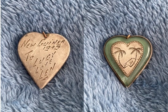 A gold locket with the inscription 'New Guinea 1995 To Lucy, Love Len' on it. The other side is jade with etched palm trees
