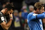Two soccer players from Italian club Azzurri look anguished.