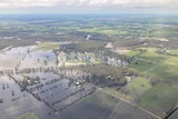 A photo taken from an aeroplane of floodwater covering paddocks and parts of the town of Moama.