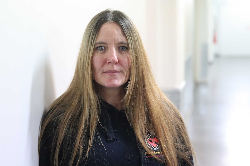 A portrait of a woman with long dark blonde hair