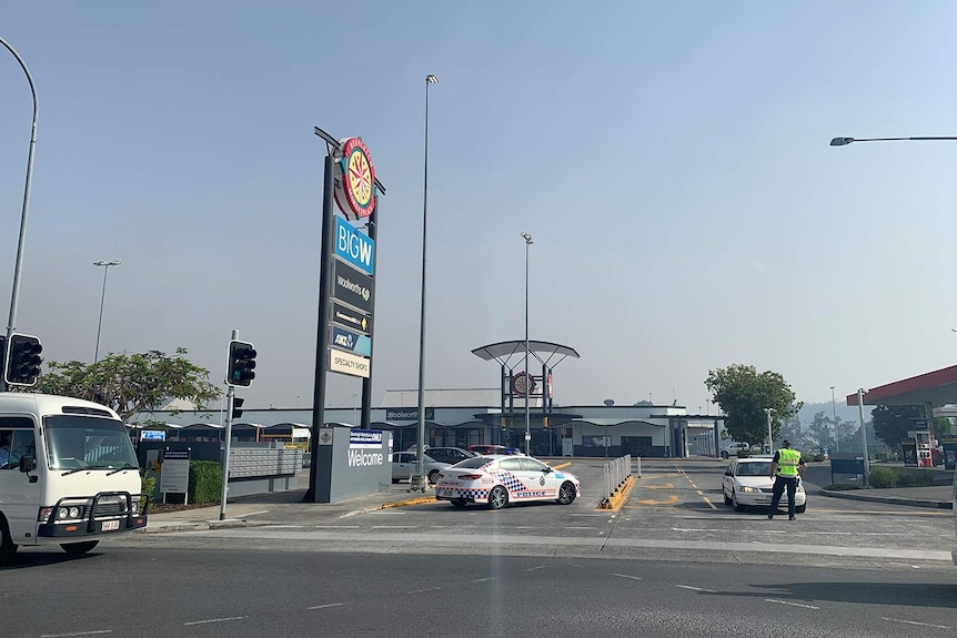 Police vehicles at Beenleigh Marketplace shopping centre, which was evacuated earlier due to a nearby bushfire.