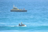 A jetski and rescue boat in the ocean.