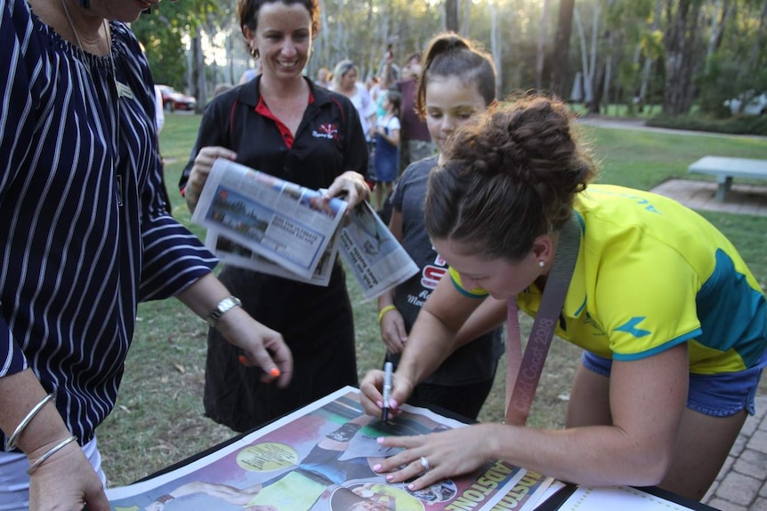 Tia Clair-Toomey signing autographs