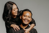 A photograph of an Indonesian husband and wife both wearing black.