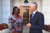 Prime Minister Malcolm Turnbull standing alongside Lucy Gichuhi.