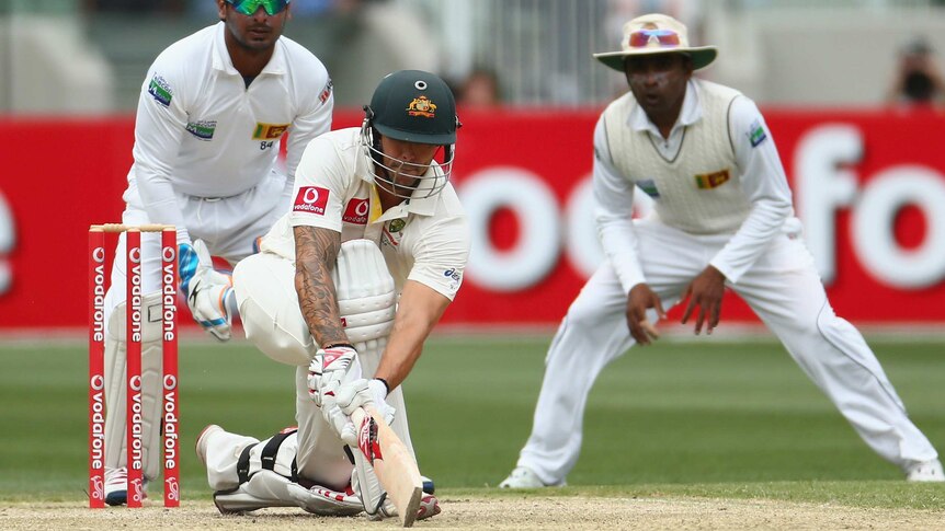 Steady knock ... Mitchell Johnson sweeps on his way to a half-century.