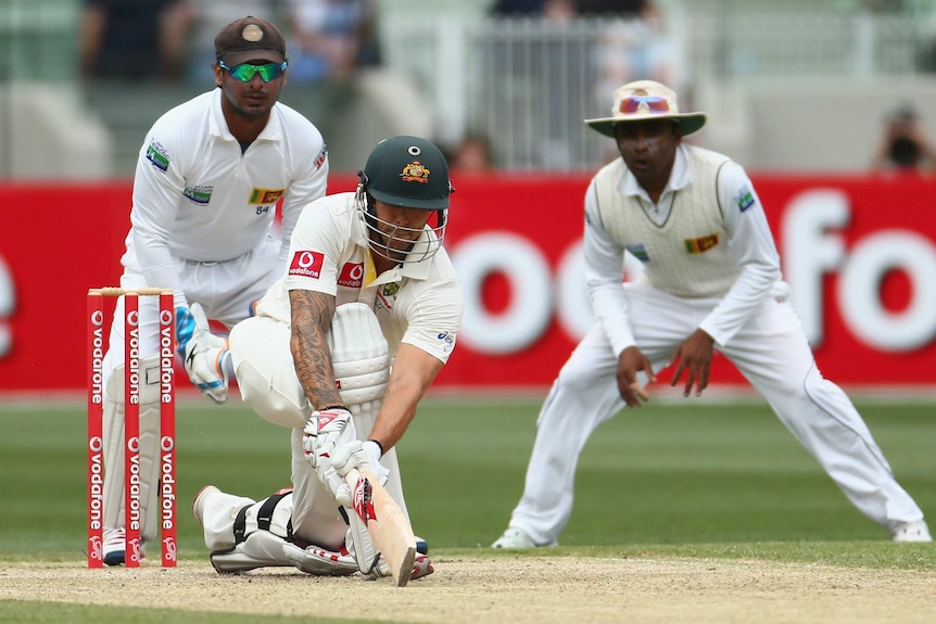 Steady knock ... Mitchell Johnson sweeps on his way to a half-century.