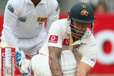 Steady knock ... Mitchell Johnson sweeps on his way to a half-century.