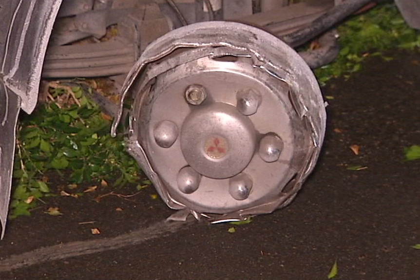 A wheel of a car with no tyre, blown out by a tyre deflation device.