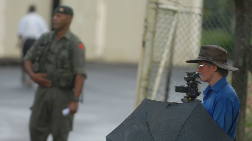 Business as usual or tightening grip? ABC correspondent Sean Dorney (R) before his deportation.