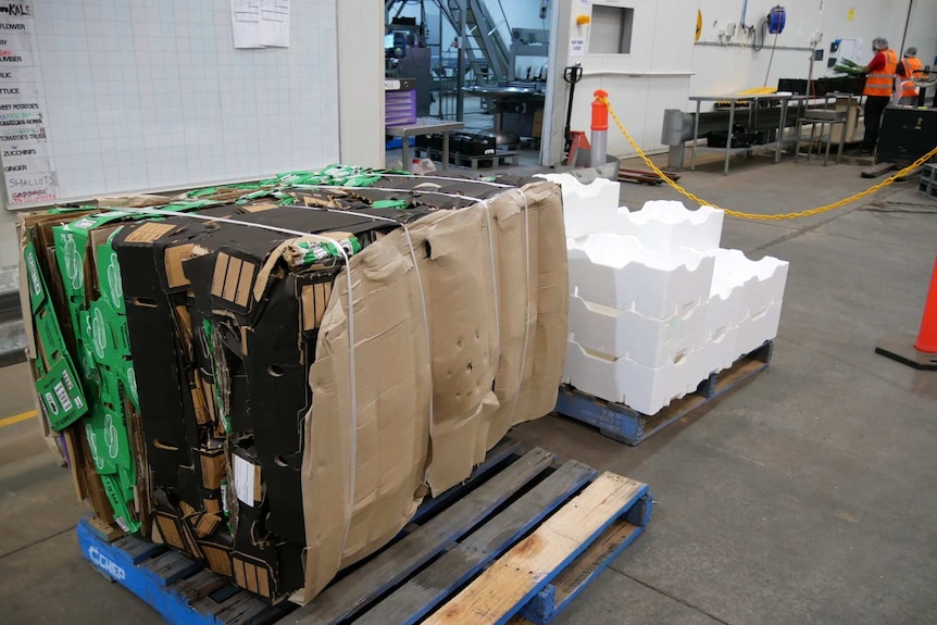 A small collection of polystyrene blocks alongside a large block of cardboard boxes