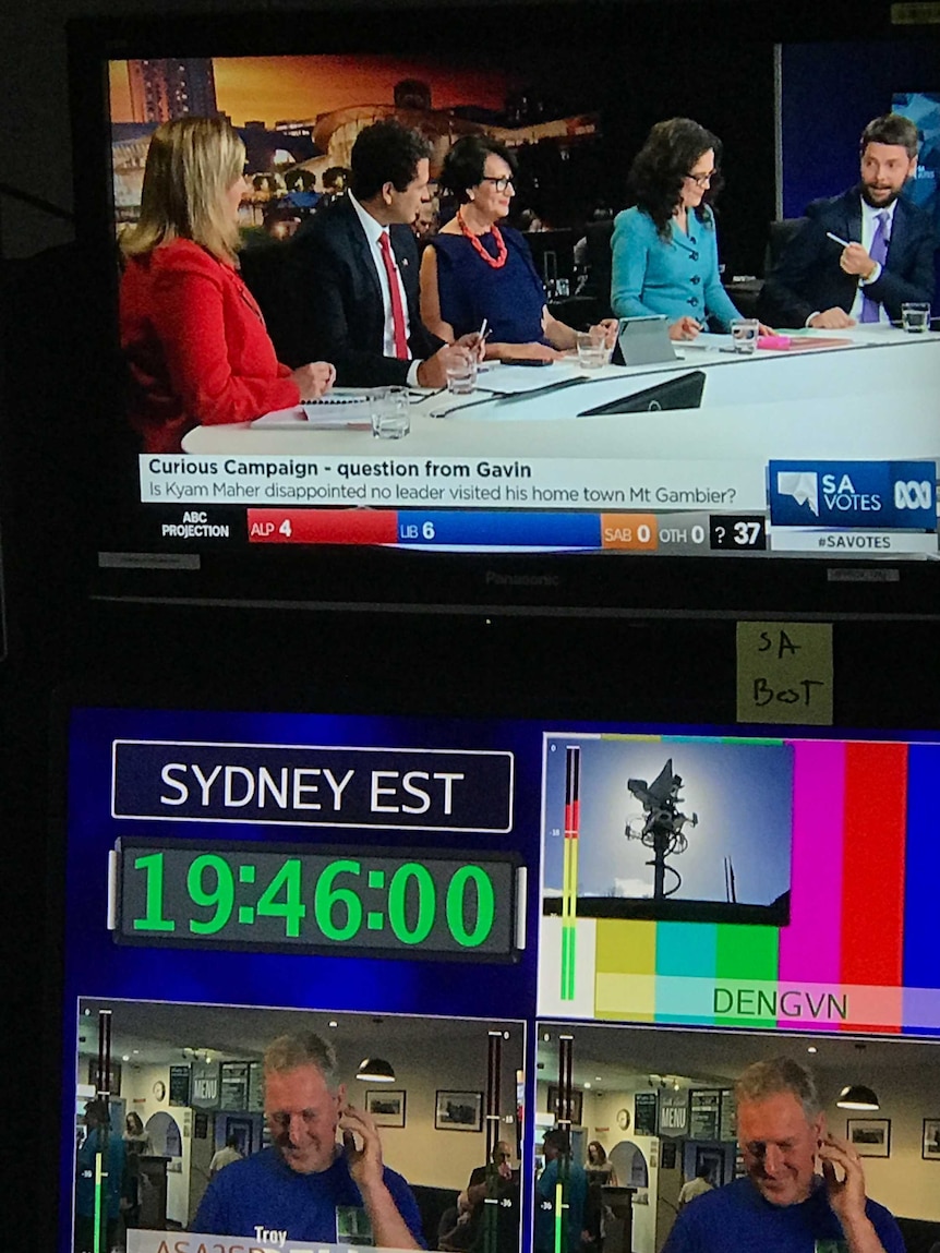TV monitors showing SA Votes election panel with question on monitor at top and live cross preparations at bottom.