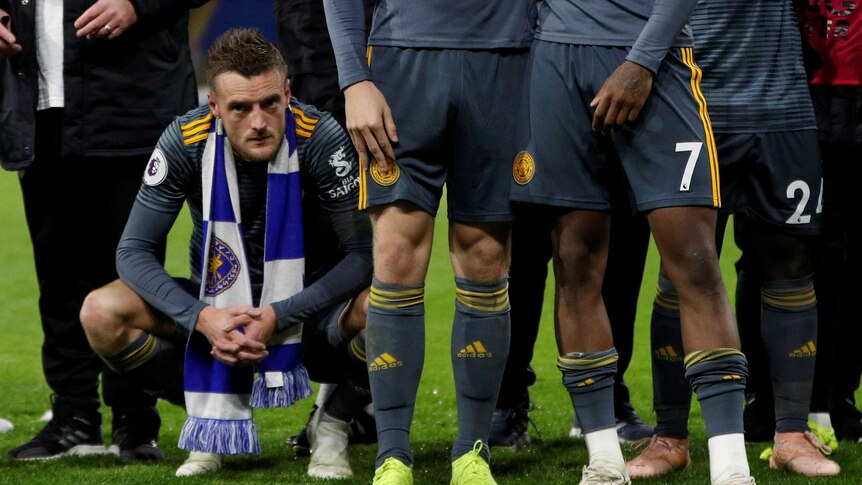 Jamie Vardy crouches down as players remember Leicester City owner