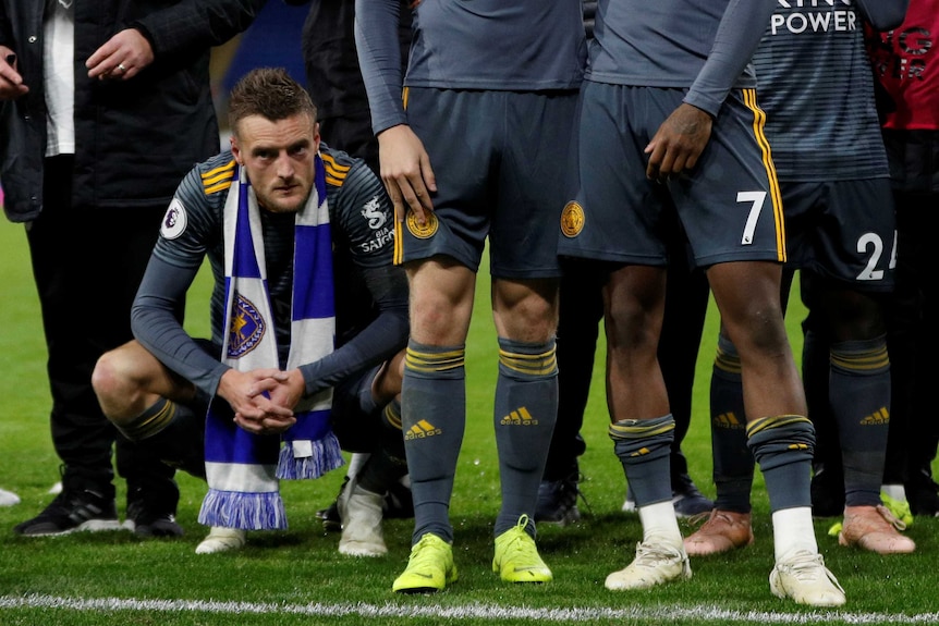 Jamie Vardy crouches down as players remember Leicester City owner
