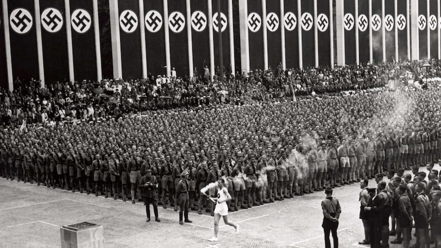 The Olympic torch is carried into the stadium in the opening ceremony of Berlin Olympics in 1936.