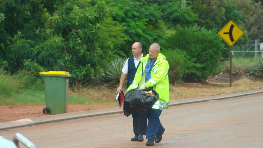 Police take material from the scene of a suspicious death of a woman in Broome.
