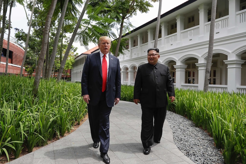 US President Donald Trump and North Korea leader Kim Jong Un walk from their lunch.