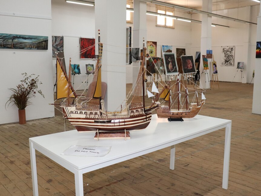 Model sailing ships on a table.
