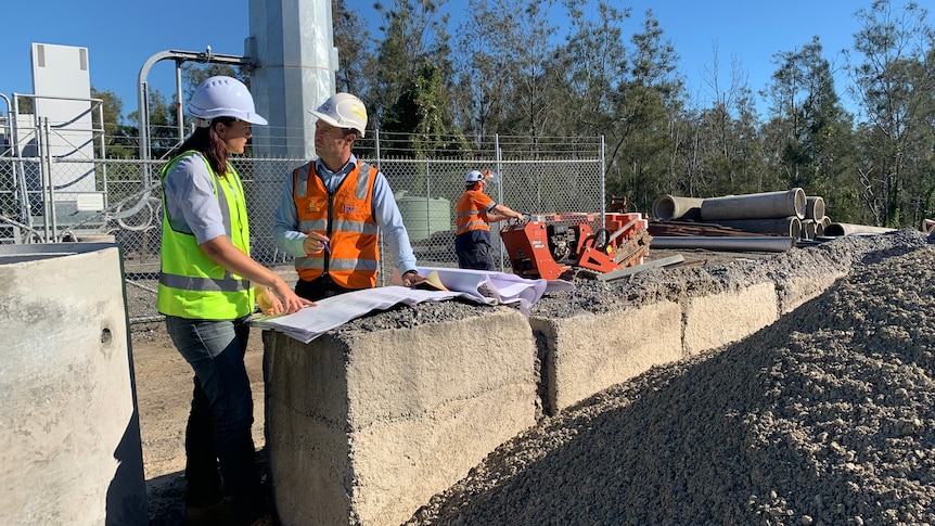 A man and a woman at a construction site.