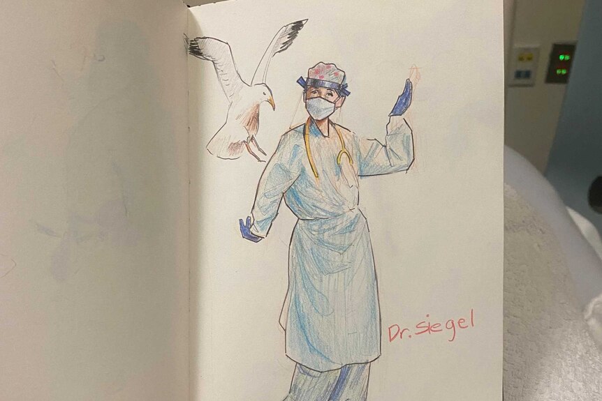David Vargas holding sketch book with drawing of Dr Siegal