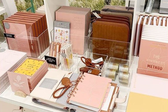 A table of kikki.K products including notebooks and diaries.